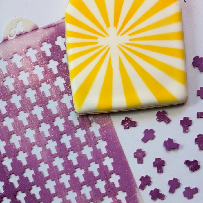 Cross Sprinkles made in purple royal icing and shown with a sugar cookie airbrushed in yellow with the Cross Sunburst Cookie Stencil