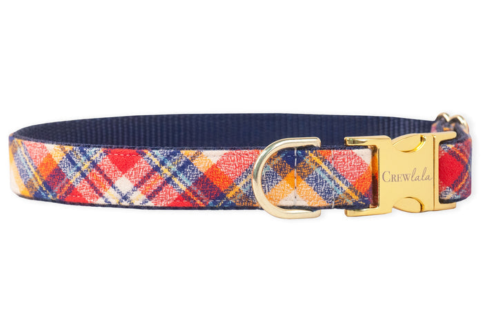 Adjustable dog collar with a colorful plaid pattern, layered over a nylon webbing base. Includes polished hardware: a buckle engraved with the brand name “Crewlala” and a secure D-ring positioned beside it.