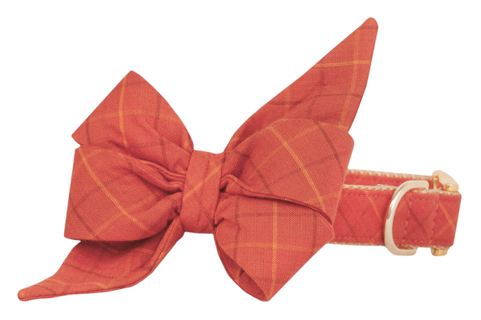 Fashionable plaid belle bow dog collar set in warm orange tones and a subtle plaid design with elongated bow tips and adjustable buckle.